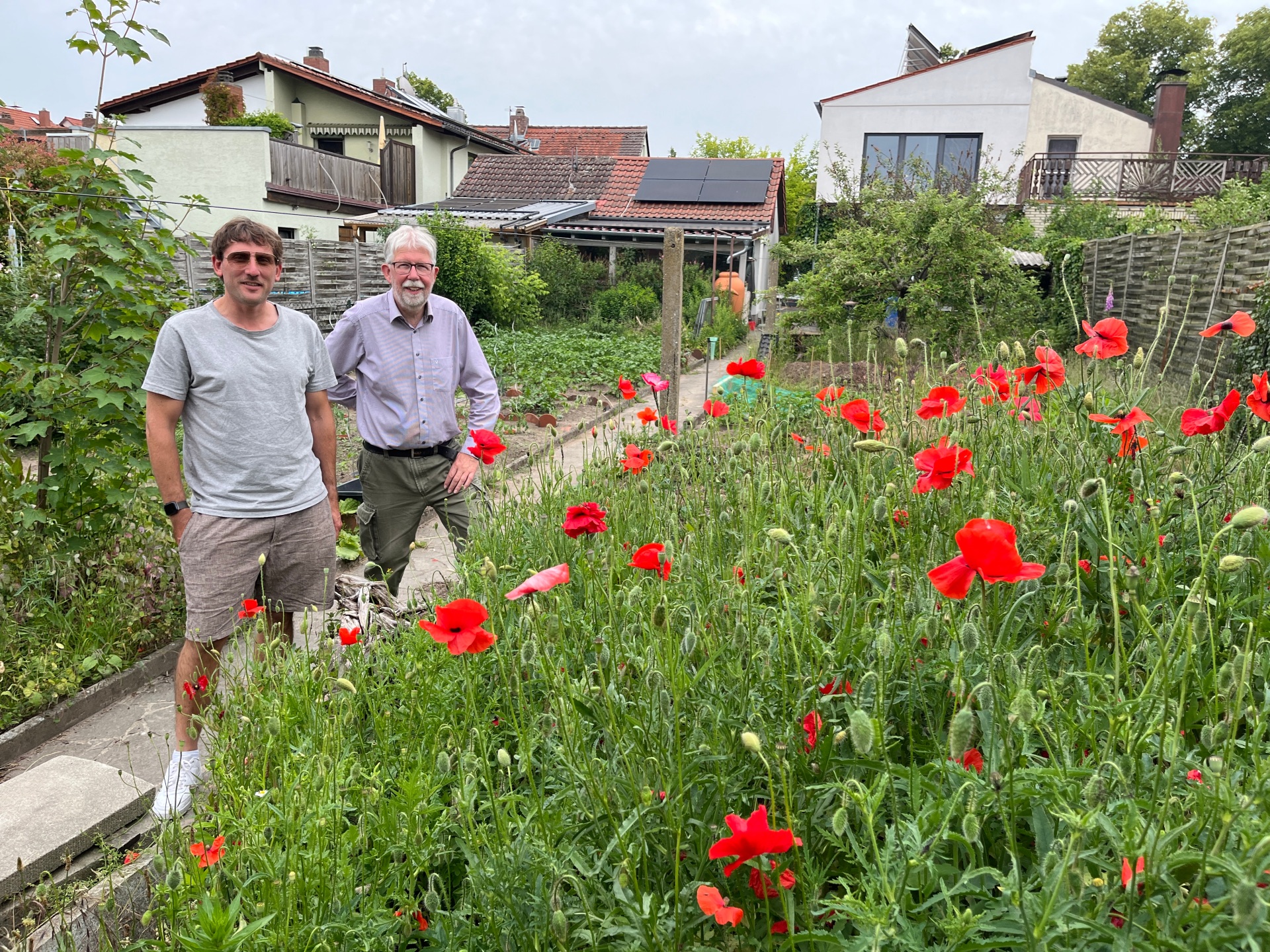  Jürgen Thorand and Jörg Dickert behind a bed of wildflowers.