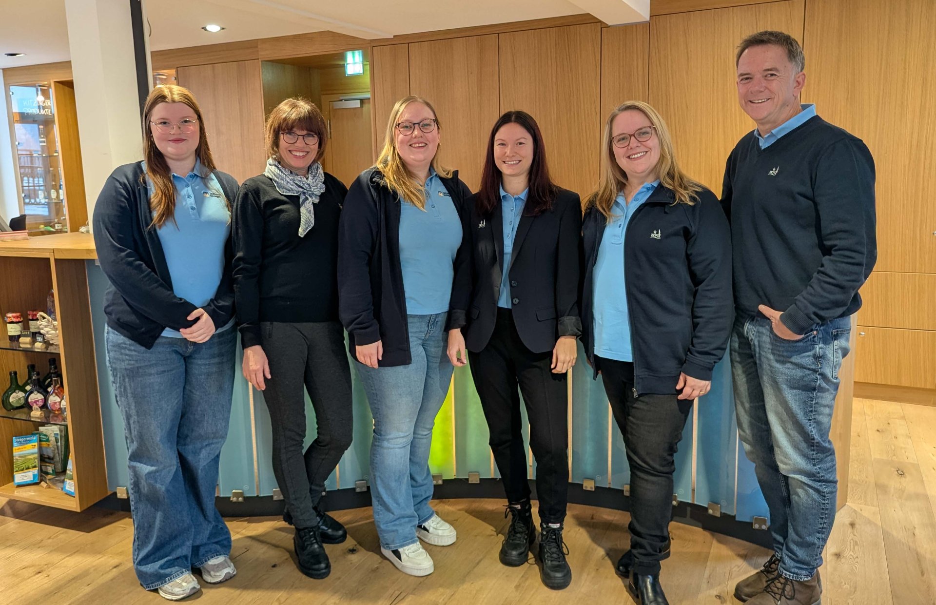 The tourist information team in front of the counter in the visiting room