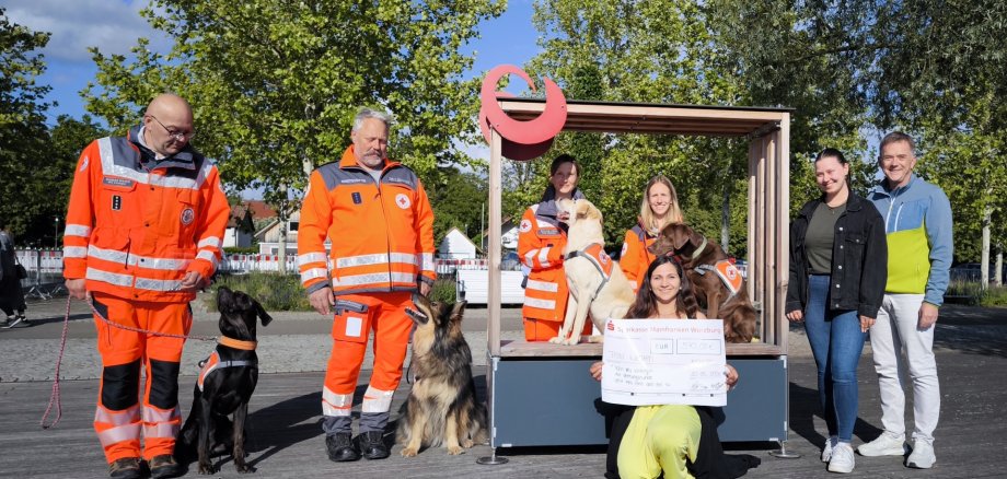 Spendenübergabe an BRK-Hunderettungsstaffel Spendenübergabe für die BRK-Hunderettungsstaffel: Sigmar Maier mit Nero, Tobias Graßliner mit Kiwi, Sylvia Veeh mit Bo, Sara Schmidt mit Hugo, Tanja Stock (Wiesenbronner Weinprinzessin), Alex Nuss (Stellv. Hofrat) kniend: Michelle Krämer (Kitzinger Kätherle).