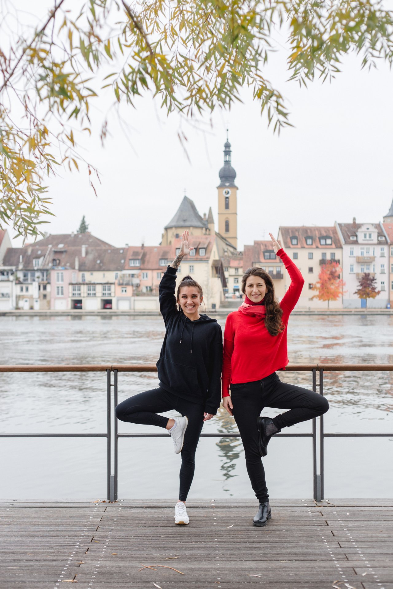 Two women do yoga on the Main