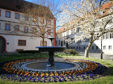 View of the fountain on the twin towns square, with the district administration office in the background