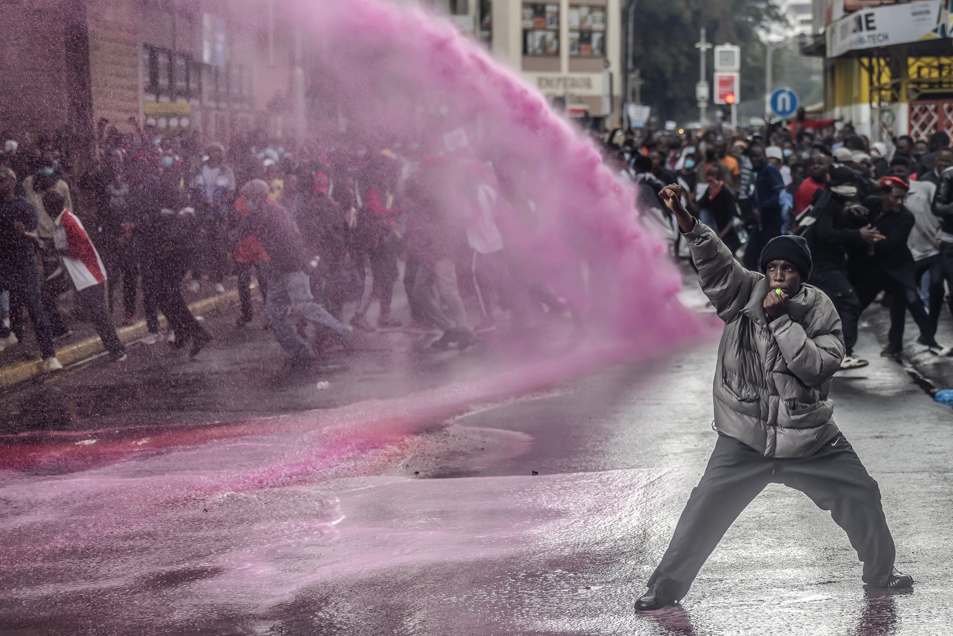 KENYA-ECONOMY-POLITICS-PARLIAMENT-DEMO A protester reacts as Kenyan police officers use water cannons to disperse a demonstration against tax hikes in downtown Nairobi on 20 June 2024. Members of Parliament voted on the Finance Bill 2024. In 2024, weeks of protests in Kenya against a new Finance Bill that proposed tax increases led to at least 60 deaths, over 400 injuries and reports of kidnappings. Tensions peaked on 25 June when demonstrators stormed parliament demanding the rejection of the bill. Violent clashes with the police led to injuries and fires around the parliament. Opposition MPs joined the demonstrators and demanded government accountability and police reform.