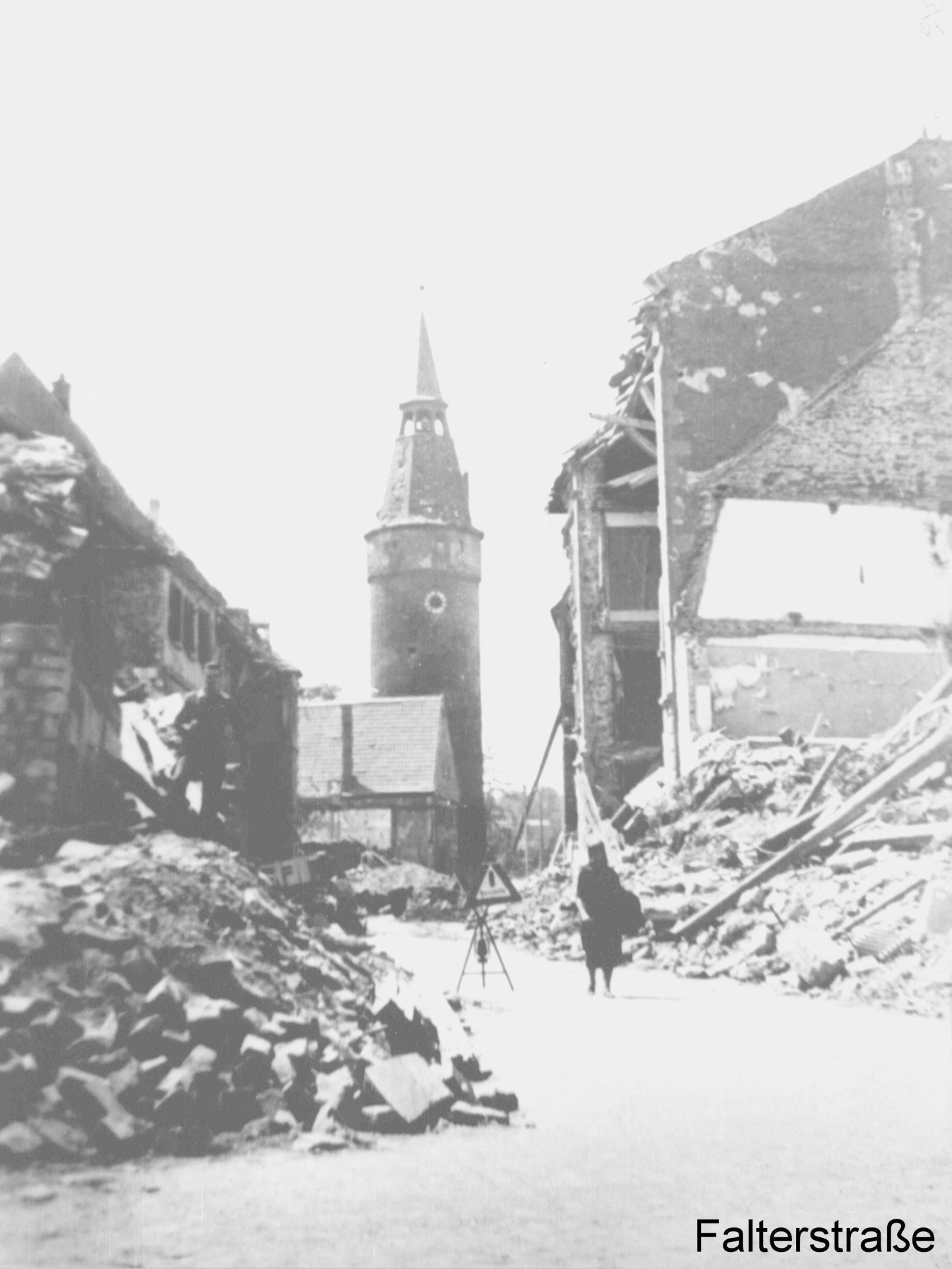 Falterstraße is largely destroyed after the air raid. The Falterturm tower still stands at the end of the street.